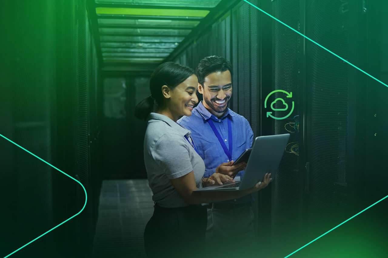 Profissionais em data center com laptop e sorriso