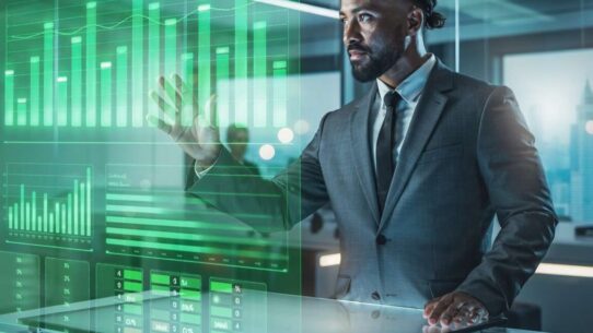 Homem de negócios interagindo com gráficos digitais.