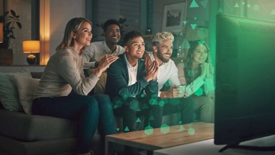 Grupo de amigos assistindo TV juntos e se divertindo.