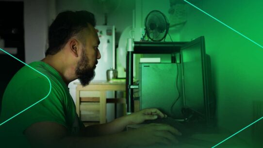 Homem trabalhando em computador em ambiente doméstico