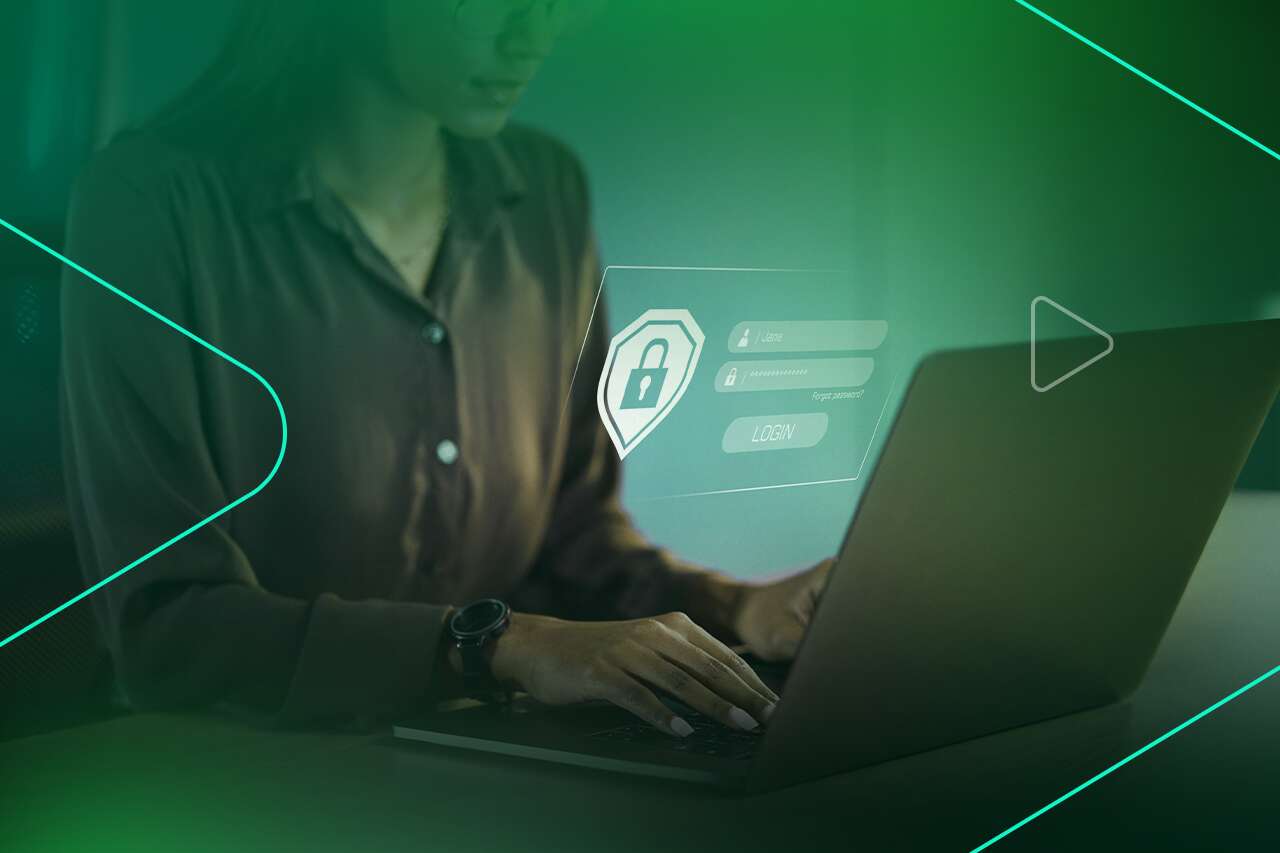 Pessoa digitando em um laptop com tela de login