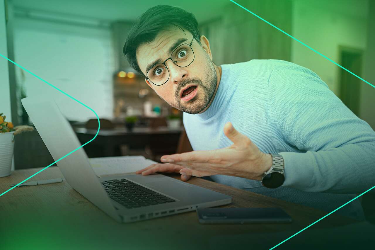 Homem surpreso usando laptop em casa