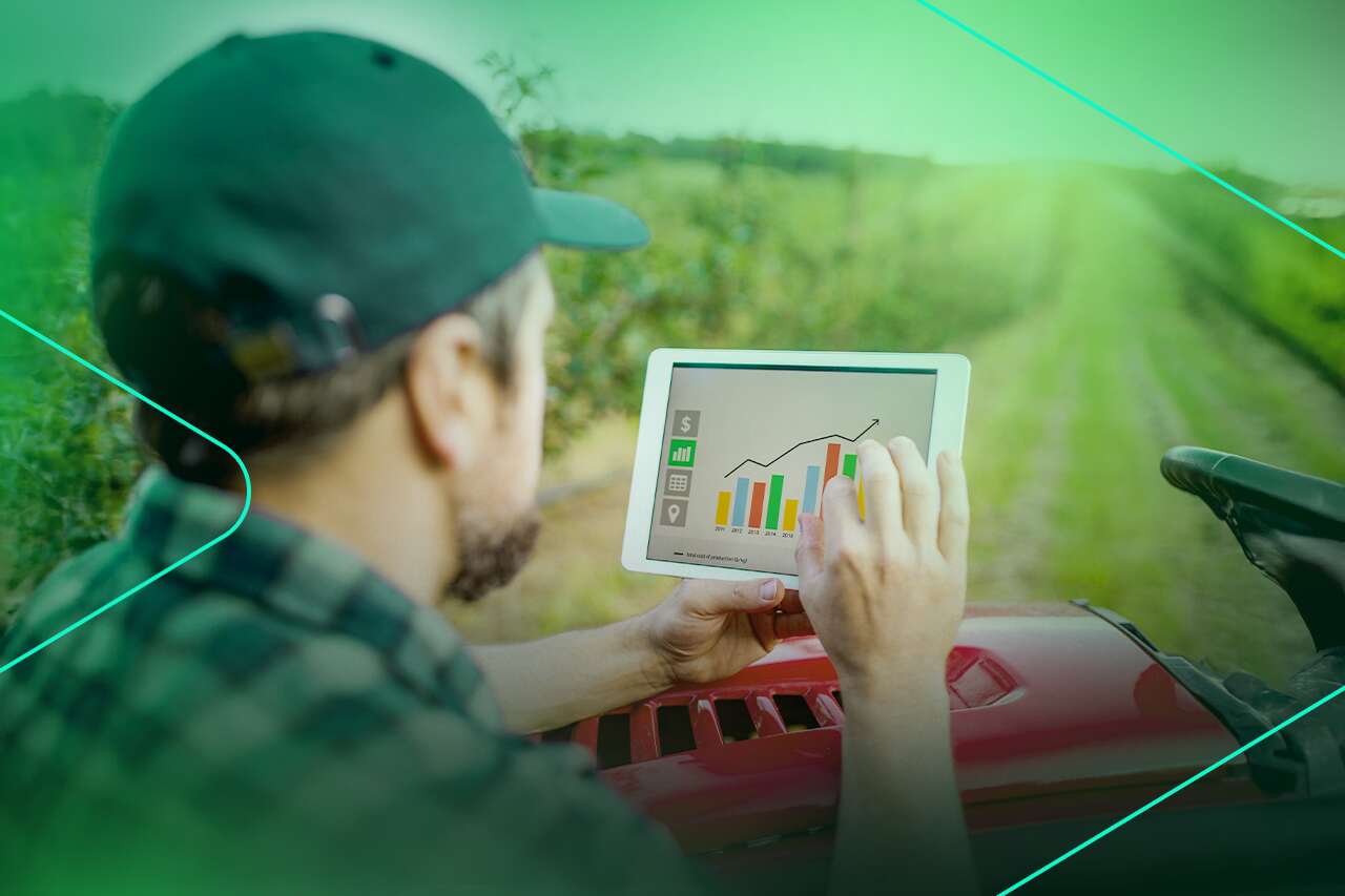 Homem analisando gráficos de dados agrícolas em tablet.