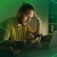 Homem preocupado usando celular em casa à noite
