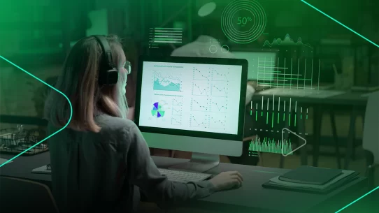 Mulher analisando dados em computador com gráficos