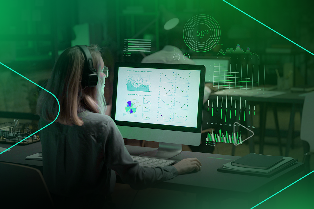 Mulher analisando dados em computador com gráficos