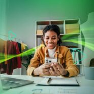 Mulher sorridente usando smartphone em ambiente criativo