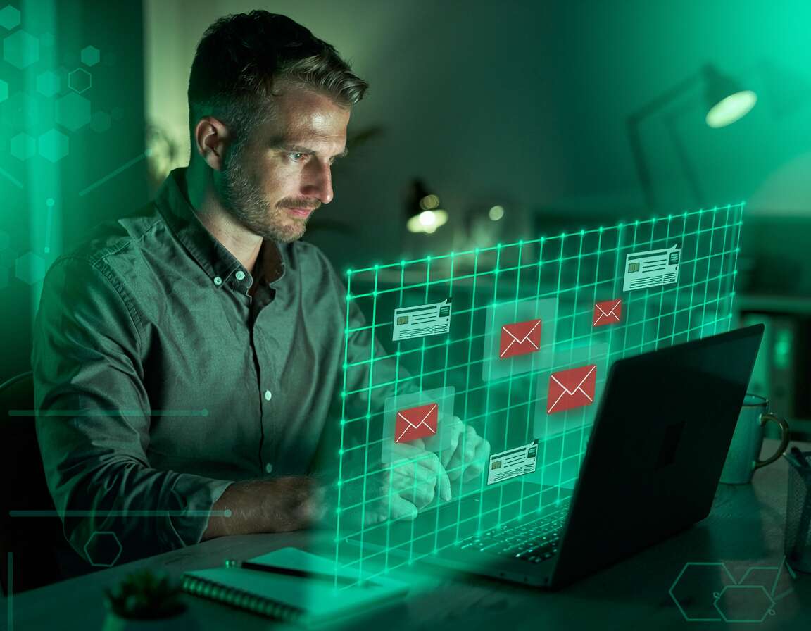 Homem analisando e-mails em computador moderno.