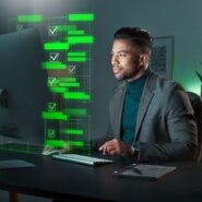 Homem em terno trabalhando em computador com gráficos.
